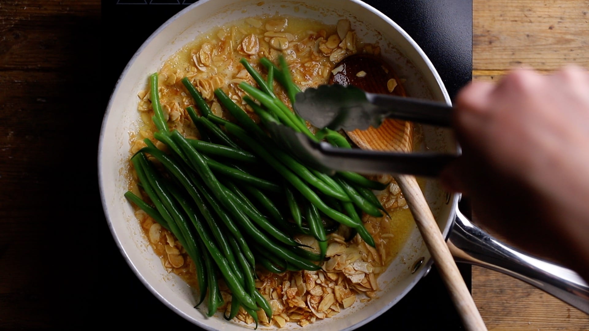 add blanched green beans into the butter and almond mix