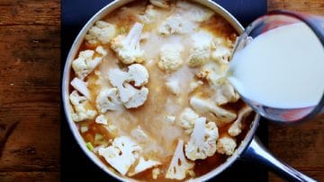 adding semi skimmed milk to the pan