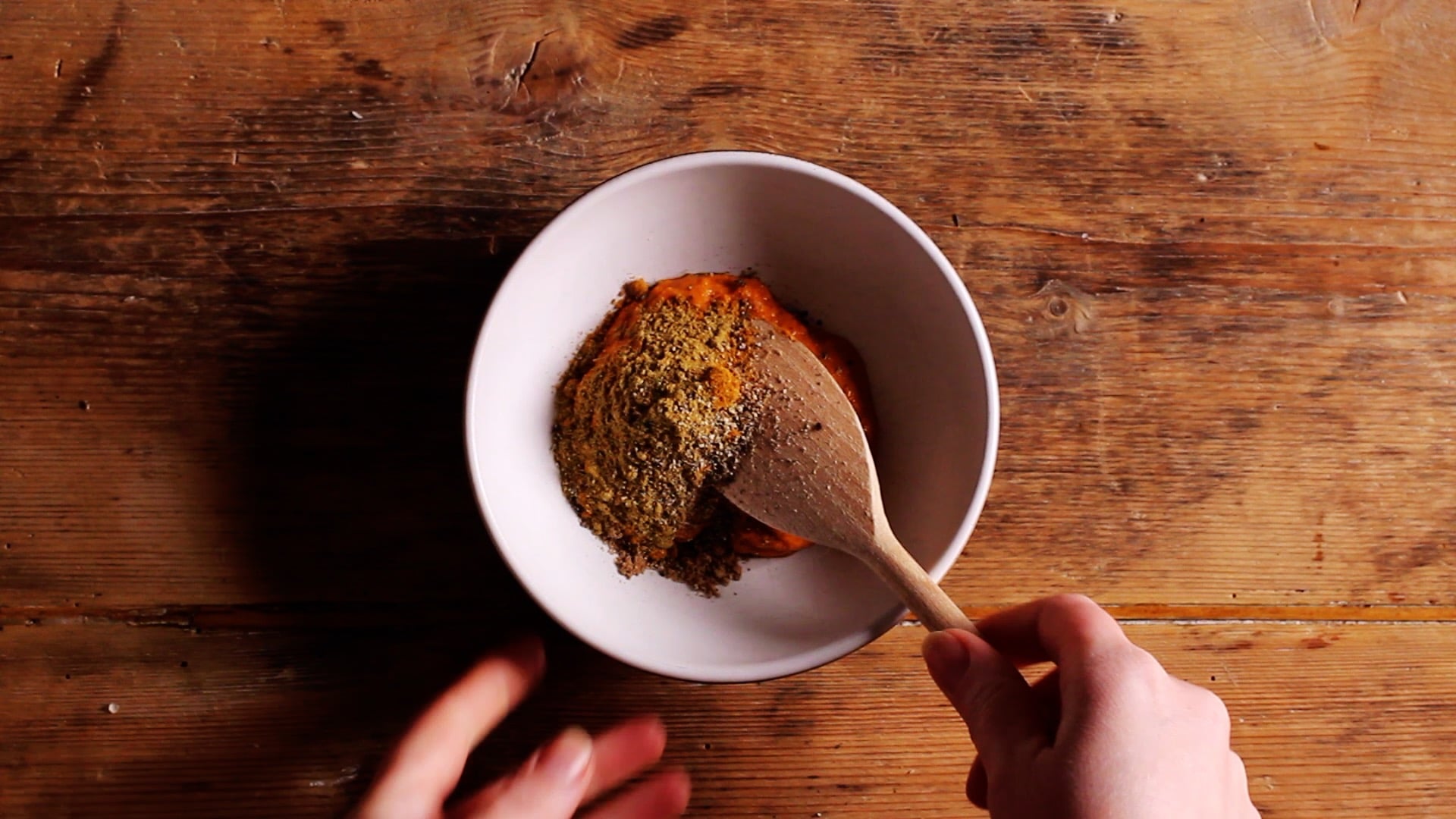 adding spices to a bowl