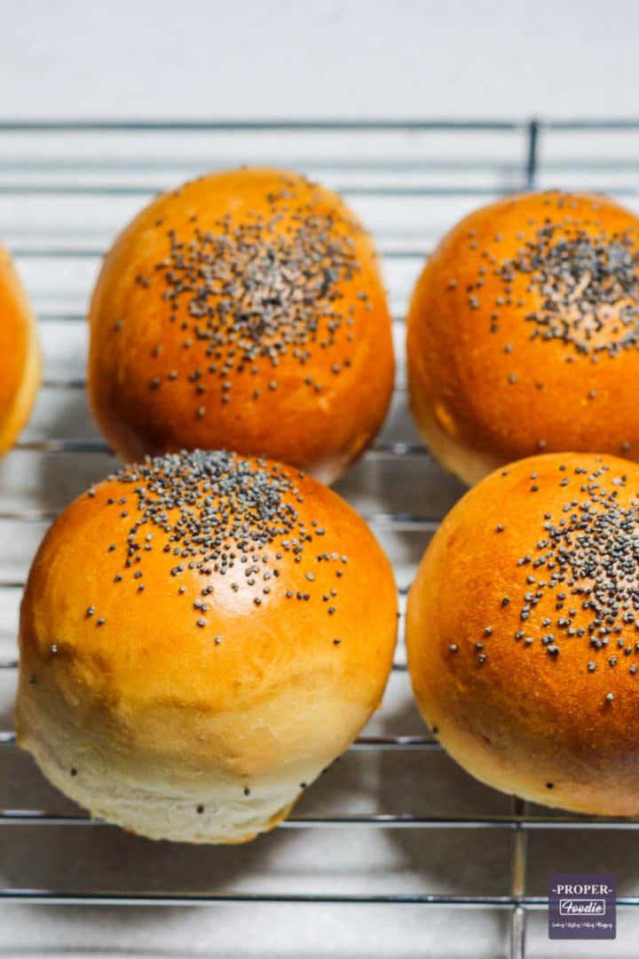 freshly baked bread rolls cooling on a wire rack