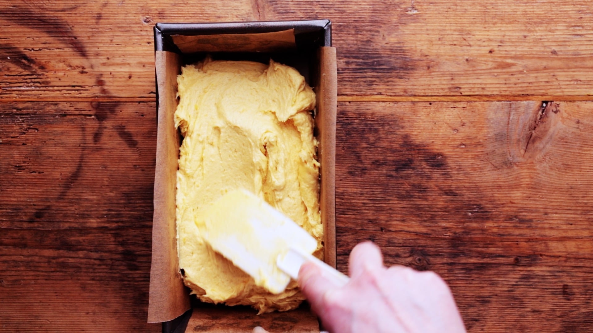 cake mixture transferred to a lined loaf tin