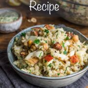 Quinoa and roasted cauliflower salad served in a small bowl sat on a blue napkin.