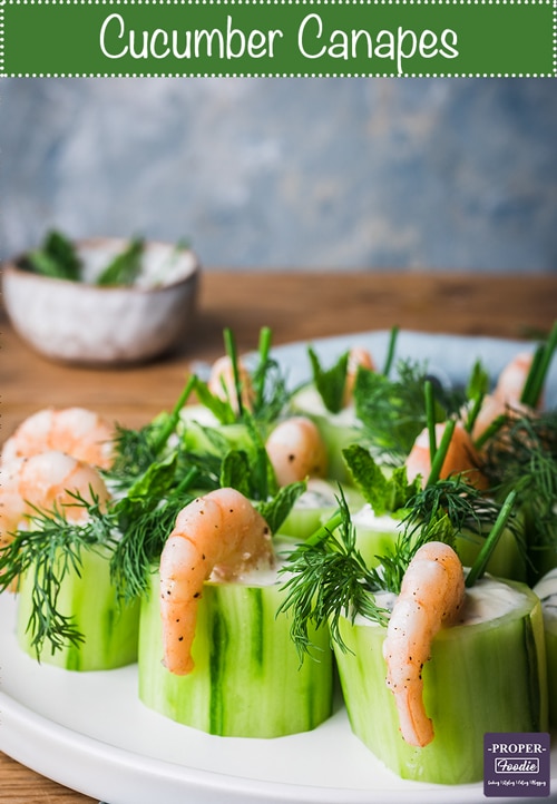 Create a classic easy finger food by making these cucumber canapes with prawns! these fancy appetisers are easy to prepare with a refreshing tzatziki filling, flavourful prawns and vibrant herb topping. Serve these for a party and your guests will be asking you for the recipe.