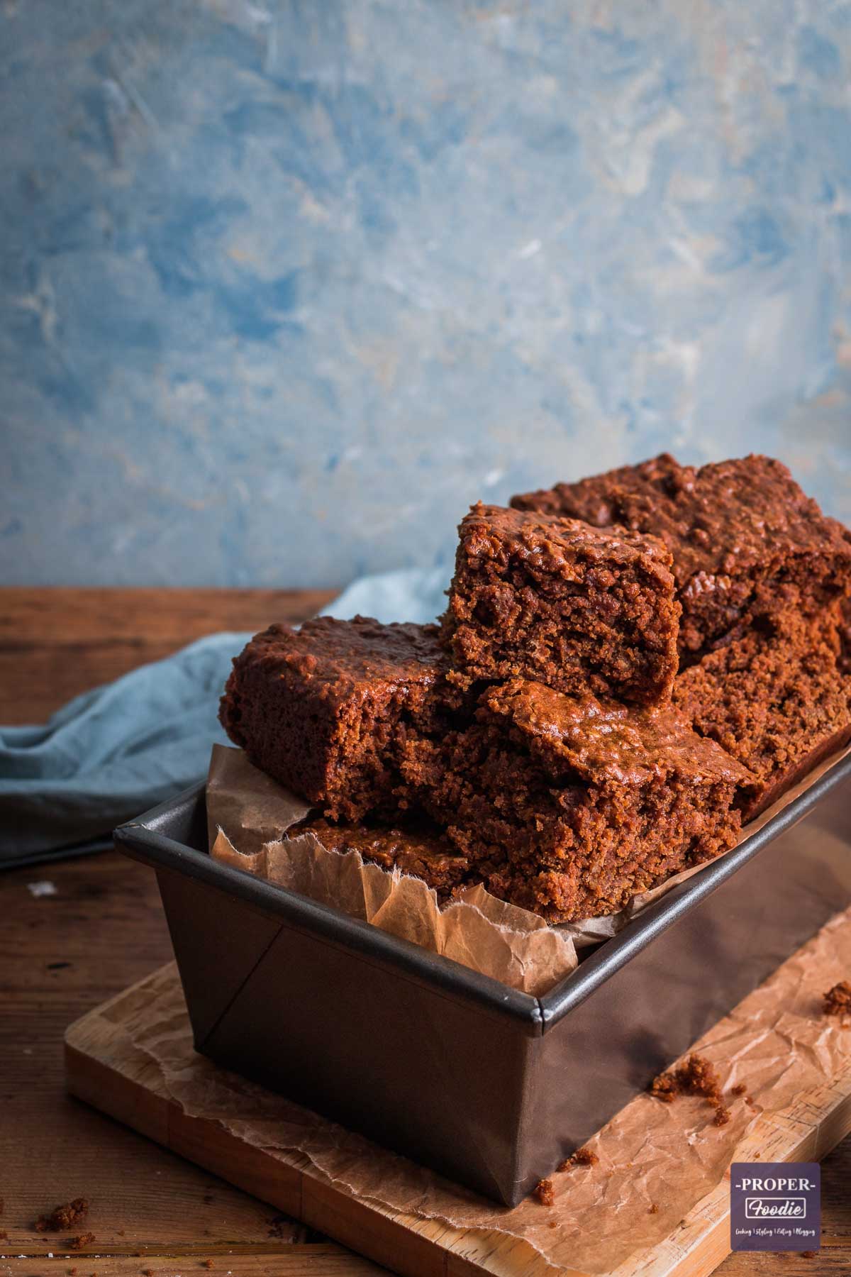 Yorkshire parkin sliced up and presented piled on top of one another in a loaf tin.