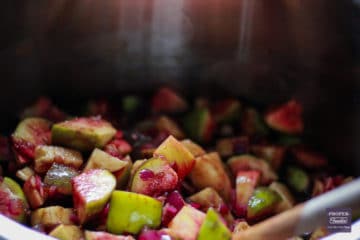 chopped figs and apples cooking in a large pan