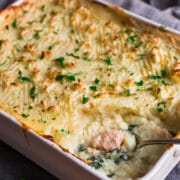 Large shallow casserole dish containing mash topped classic fish pie, baked until crisp and golden brown.