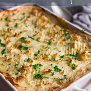 Oblong baking dish containing classic fish pie recipe with a mash potato topping that has been marked with a fork and baked until crisp.