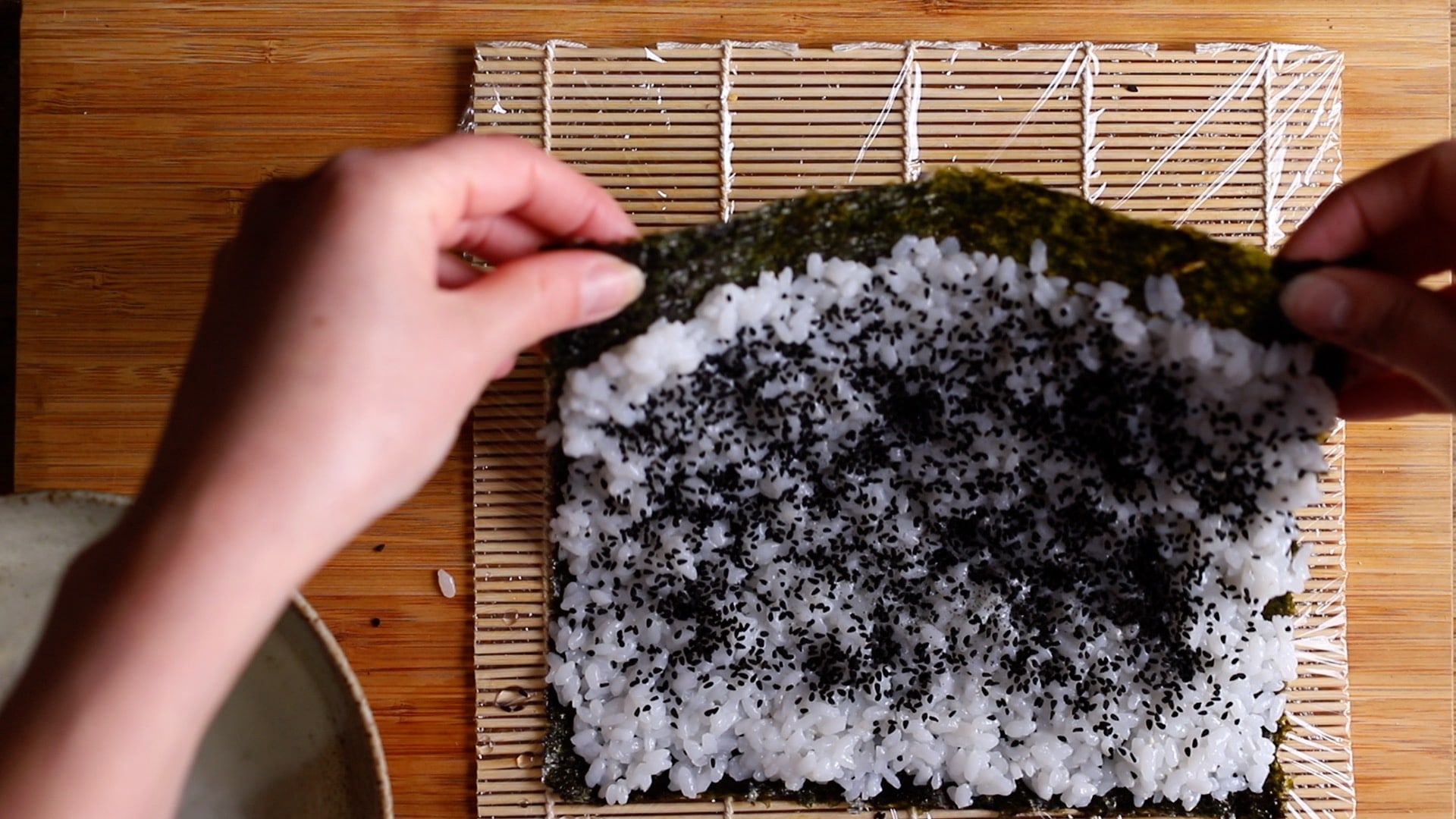 flip over rice and nori so rice is on the underside