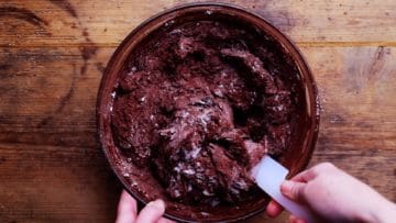 folding flour and cocoa into the brownie mix