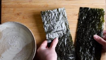 for maki sushi fold and cut the sheet of nori in half