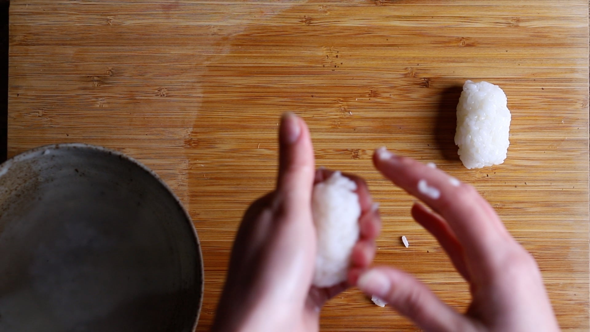 shaping the rice into small oblong balls