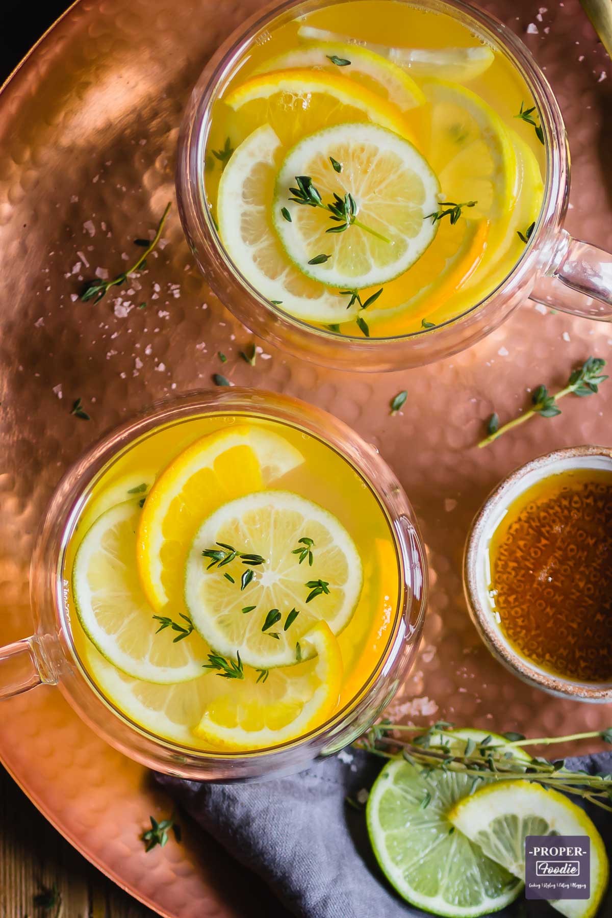 Honey and lemon tea in a glass tea cup viewed from above.