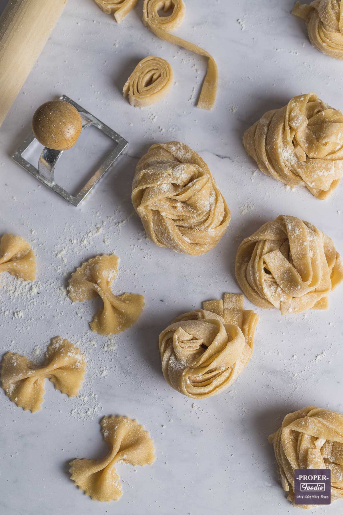 Homemade strips of pasta wrapped into nests and sprinkled with semolina flour.