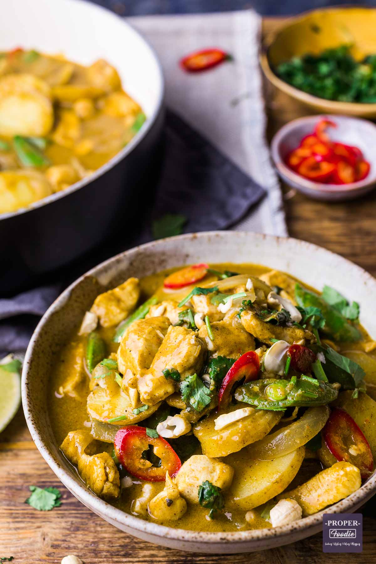 A bowl of chicken and potato curry in a coconut cream sauce.