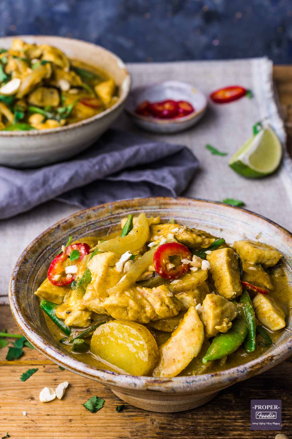 A bowl of Thai curry made with chicken, sliced potatoes and massaman curry sauce.