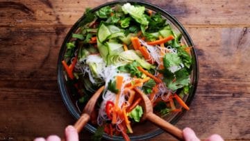 mixing salad and noodles