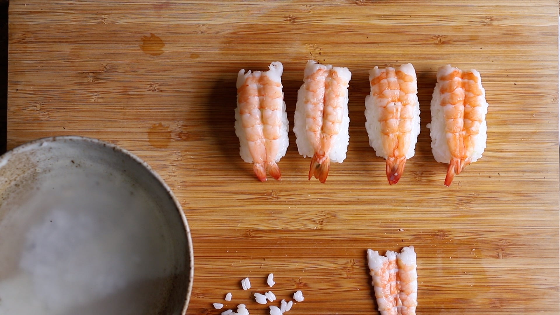 sushi rice topped with butterflied king prawns