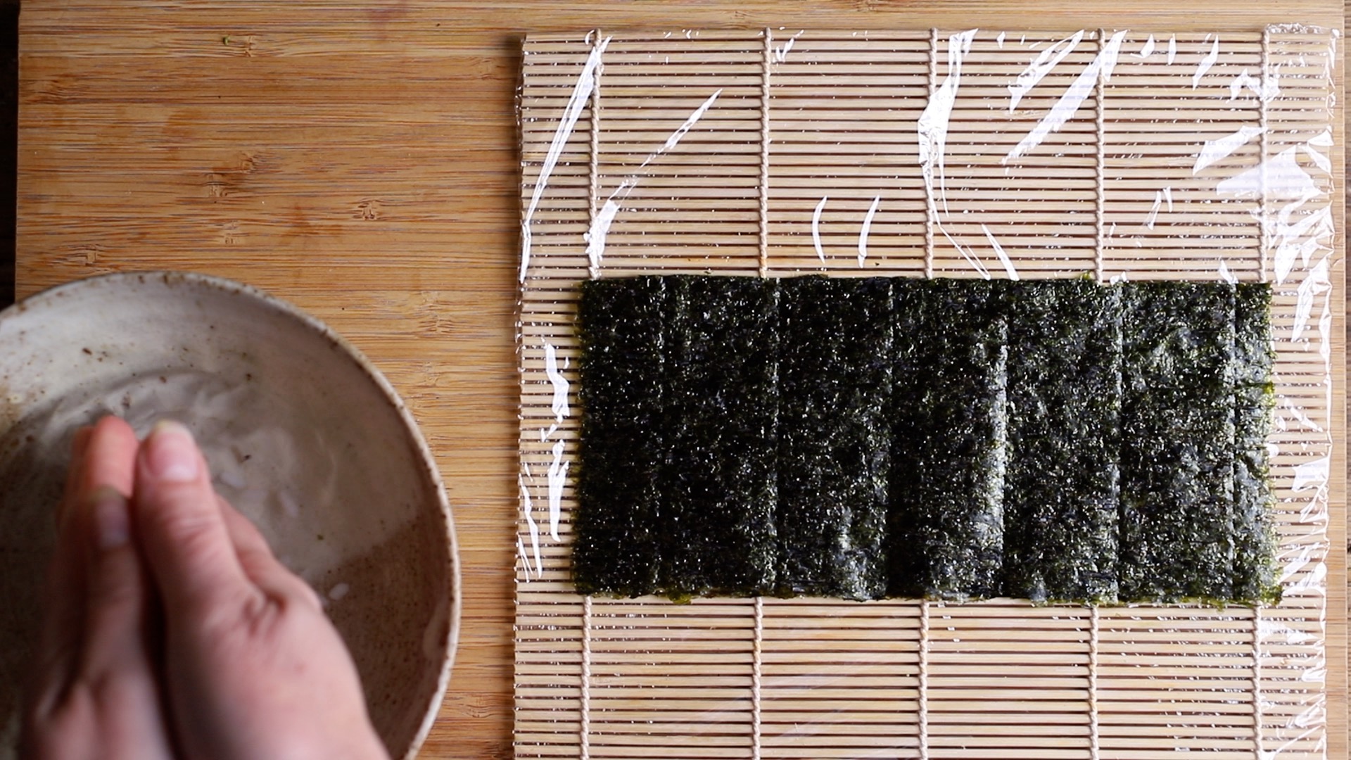 seaweed sheet in centre of bamboo mat