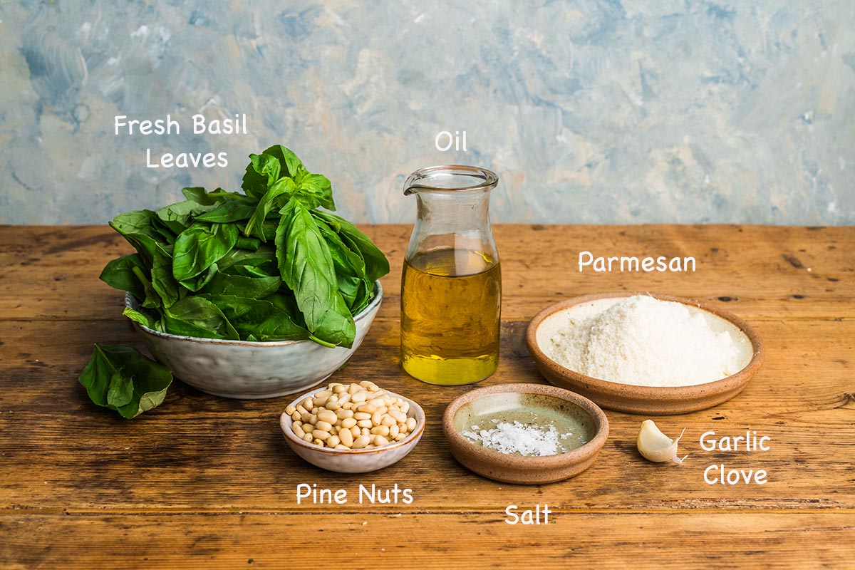 The ingredients required to make homemade basil pesto.