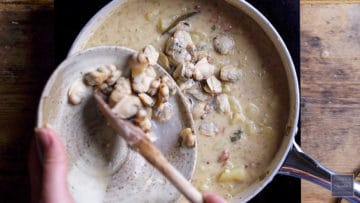 remove cooked clams from their shells and add to the chowder