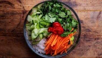 salad ingredients and cooked noodles in large mixing bowl