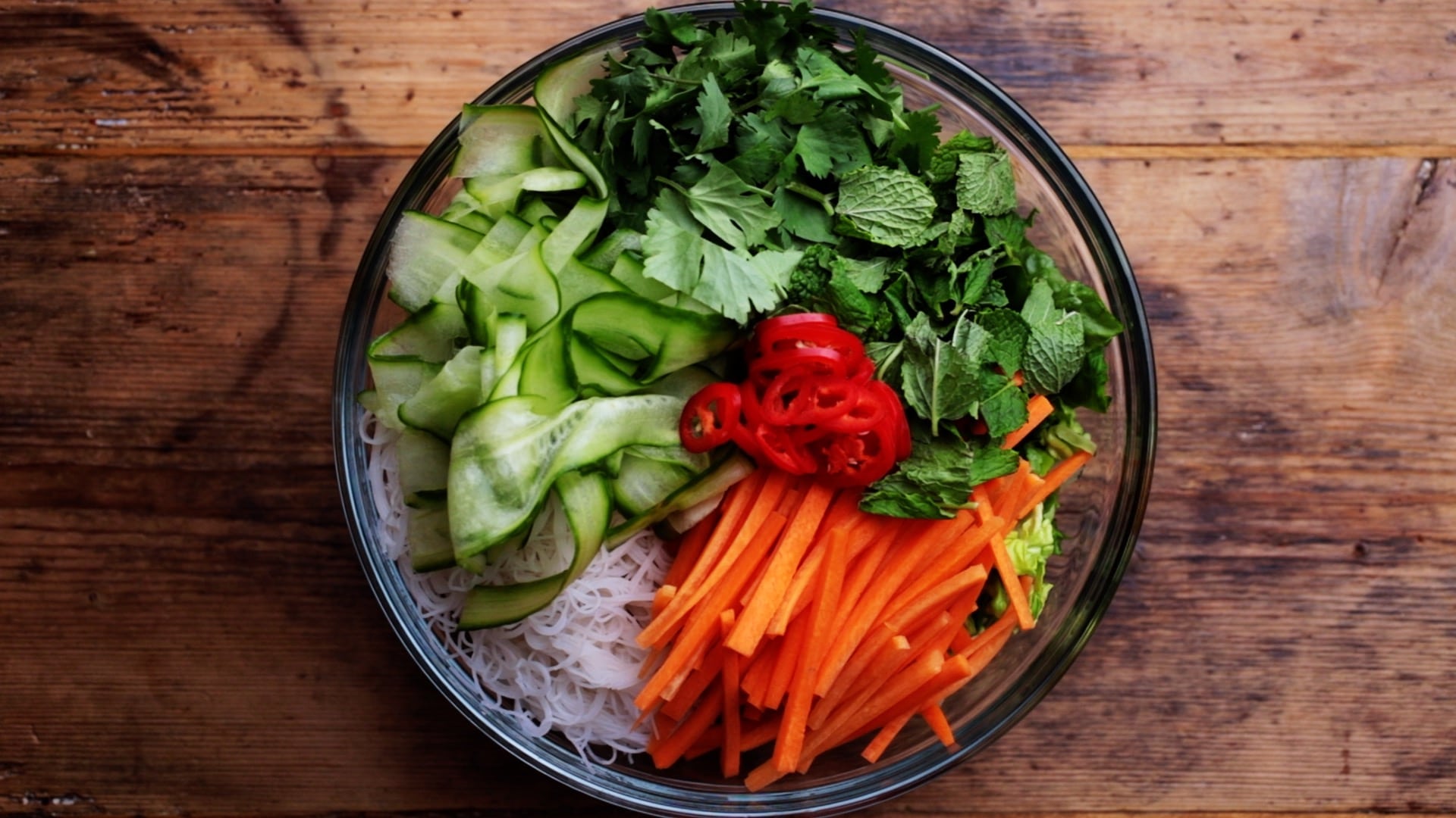 salad ingredients and cooked noodles in large mixing bowl