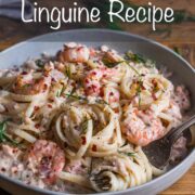 A bowl of linguine in a creamy sauce with salmon and prawns.