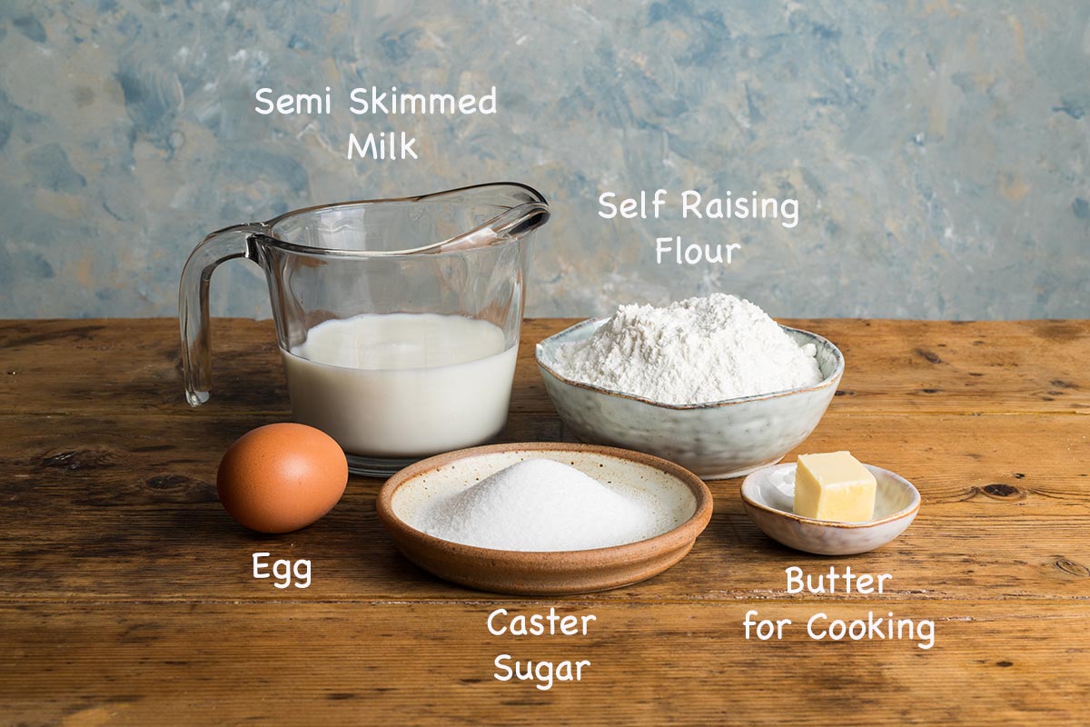 A display of the ingredients needed to make Scotch pancakes recipe with text overlay stating each ingredients.