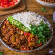 chilli con carne in a bowl with cannellini beans and rice.