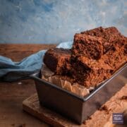 Yorkshire parkin sliced up and presented piled on top of one another in a loaf tin.