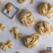 Homemade strips of pasta wrapped into nests and sprinkled with semolina flour.