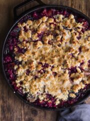 Rhubarb crumble recipe in a round cast iron pan with spoon