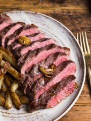 Rump steak cooked medium-rare. sliced into strips and resented on a plate with home made chips on the side.