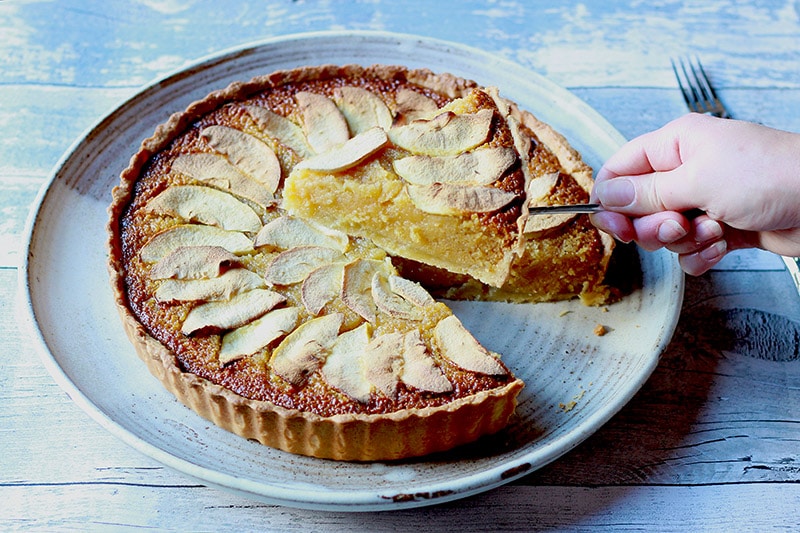 sticky apple treacle tart taking slice