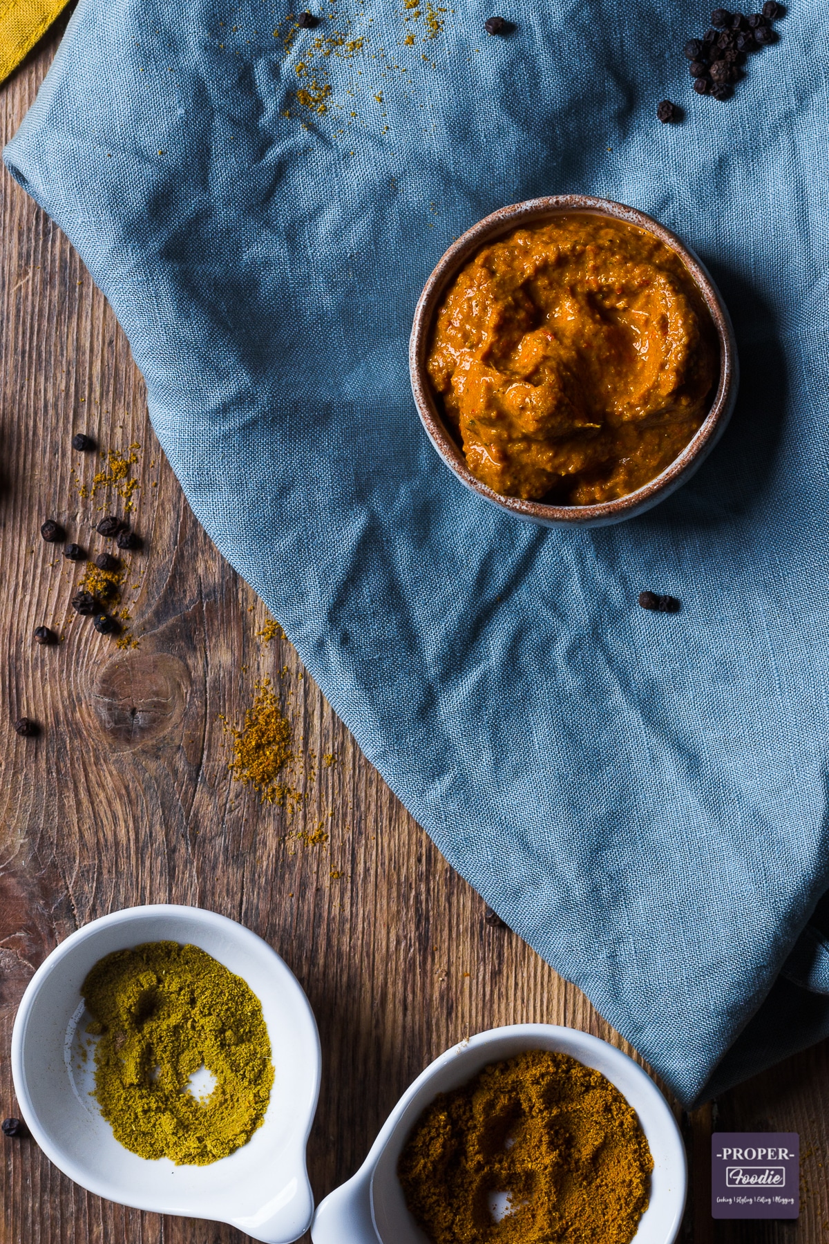 Thai yellow curry paste in a small dish with spices at the side