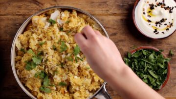 top biryani with coriander and serve with yogurt