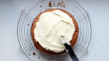 Top the cake with the remaining half of cream cheese frosting