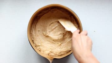 Transfer the banana cake mix to a lined cake tin